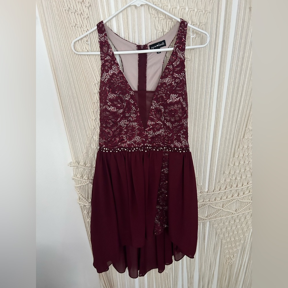 Wine colored romper style dress. Sequined with pearl bodice, sheer mini train